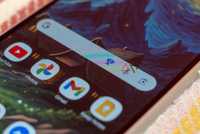 a closeup of a phone with focus on the google search widget