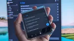 Samsung Galaxy Z Flip 7 smartphone cover screen showing Microsoft To Do app with listed tasks and the Windows equivalent in the background displayed on a PC monitor